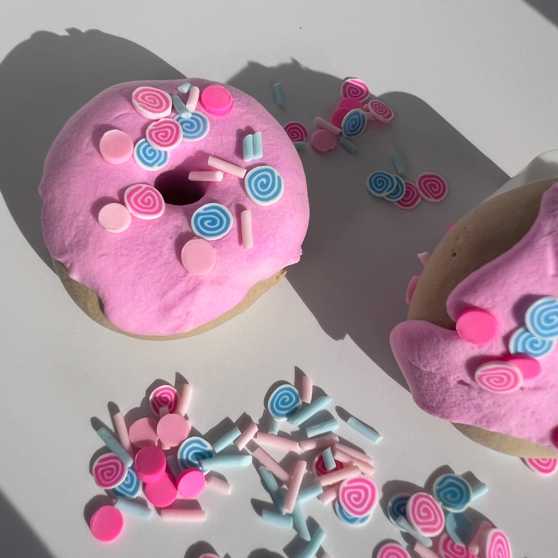 Soft pastel yellow butter slime with a rich, spreadable texture, featuring vibrant clay donut charms and candy sprinkles. Infused with a delicious glazed donut aroma, perfect for relaxing play.